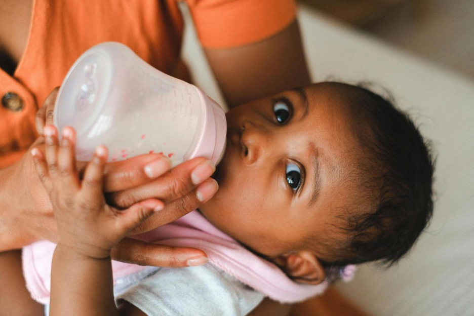 Baby drinking expressed breast milk from a bottle